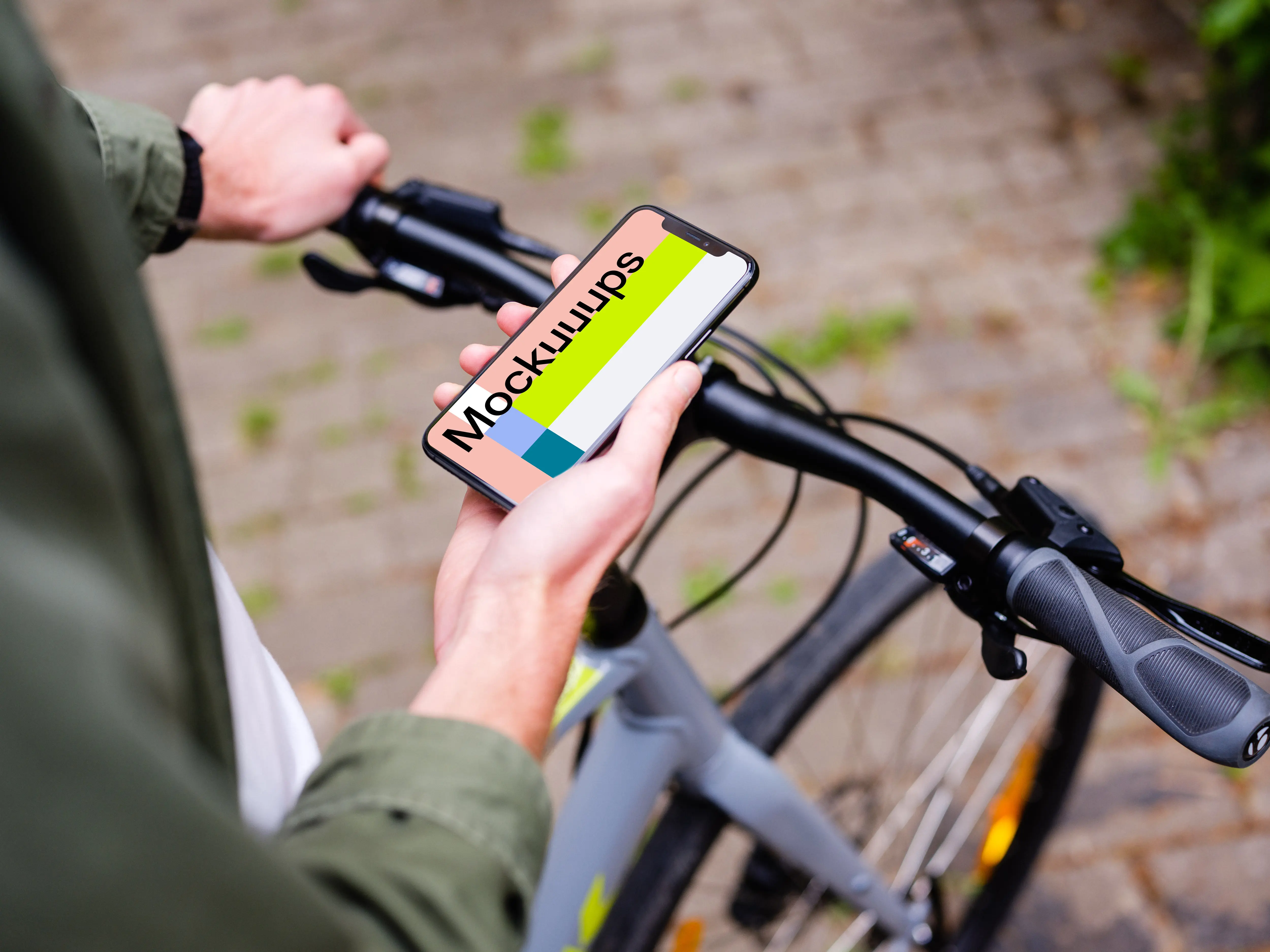 Holding an iPhone 11 Pro mockup while waiting on a bike