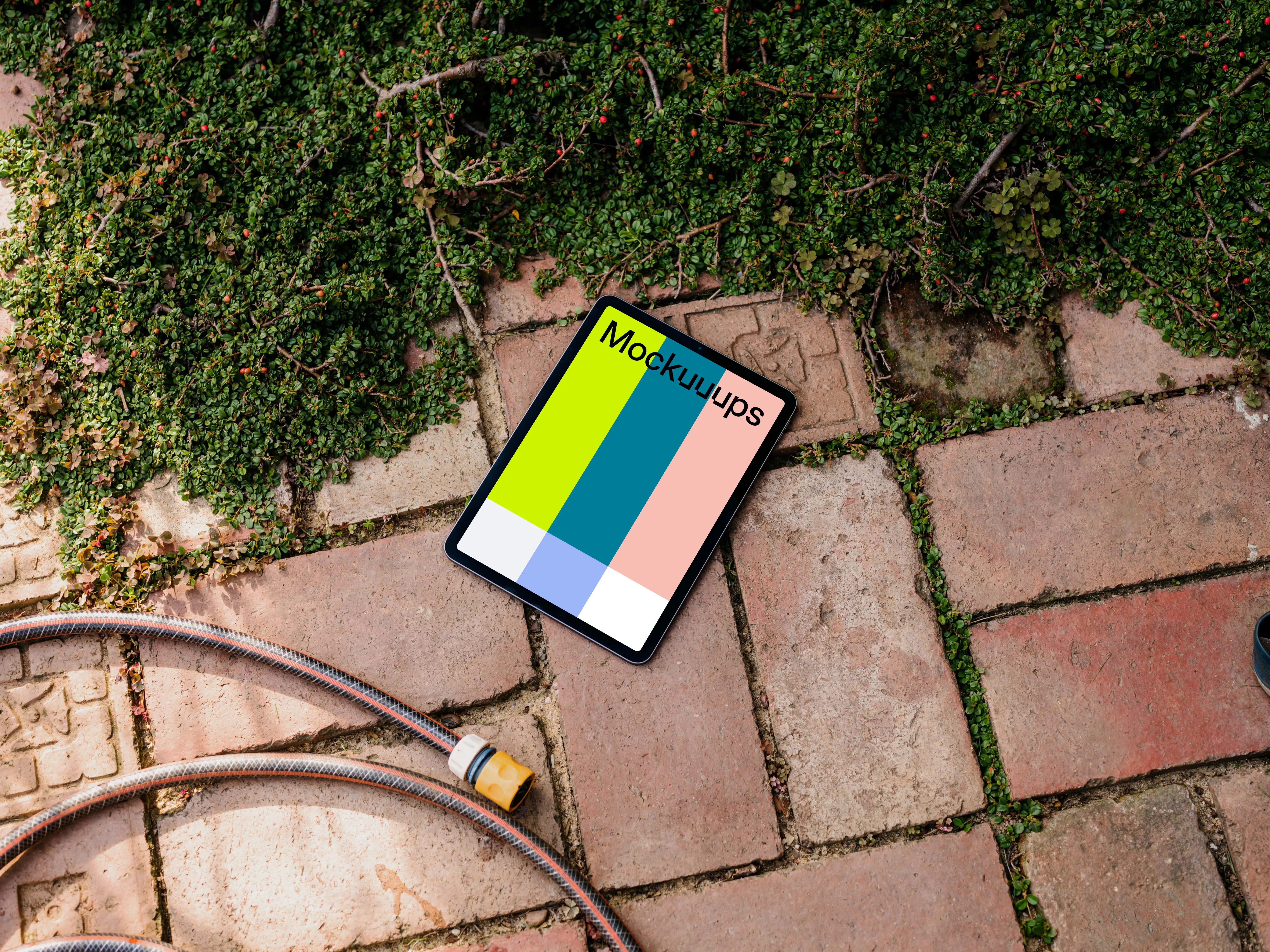 iPad Air mockup on a garden paving with plants