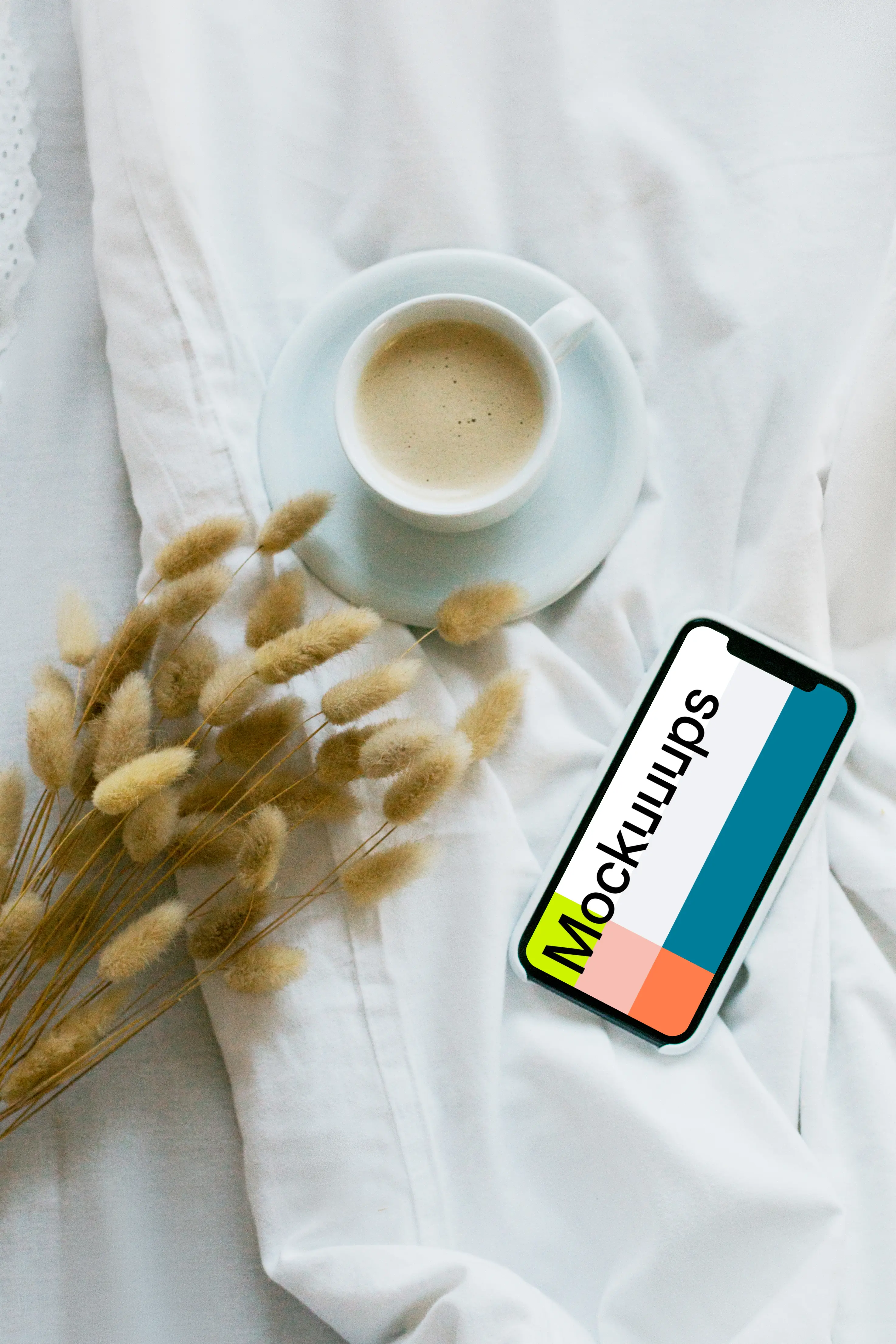 iPhone 12 mockup with a cup of coffee