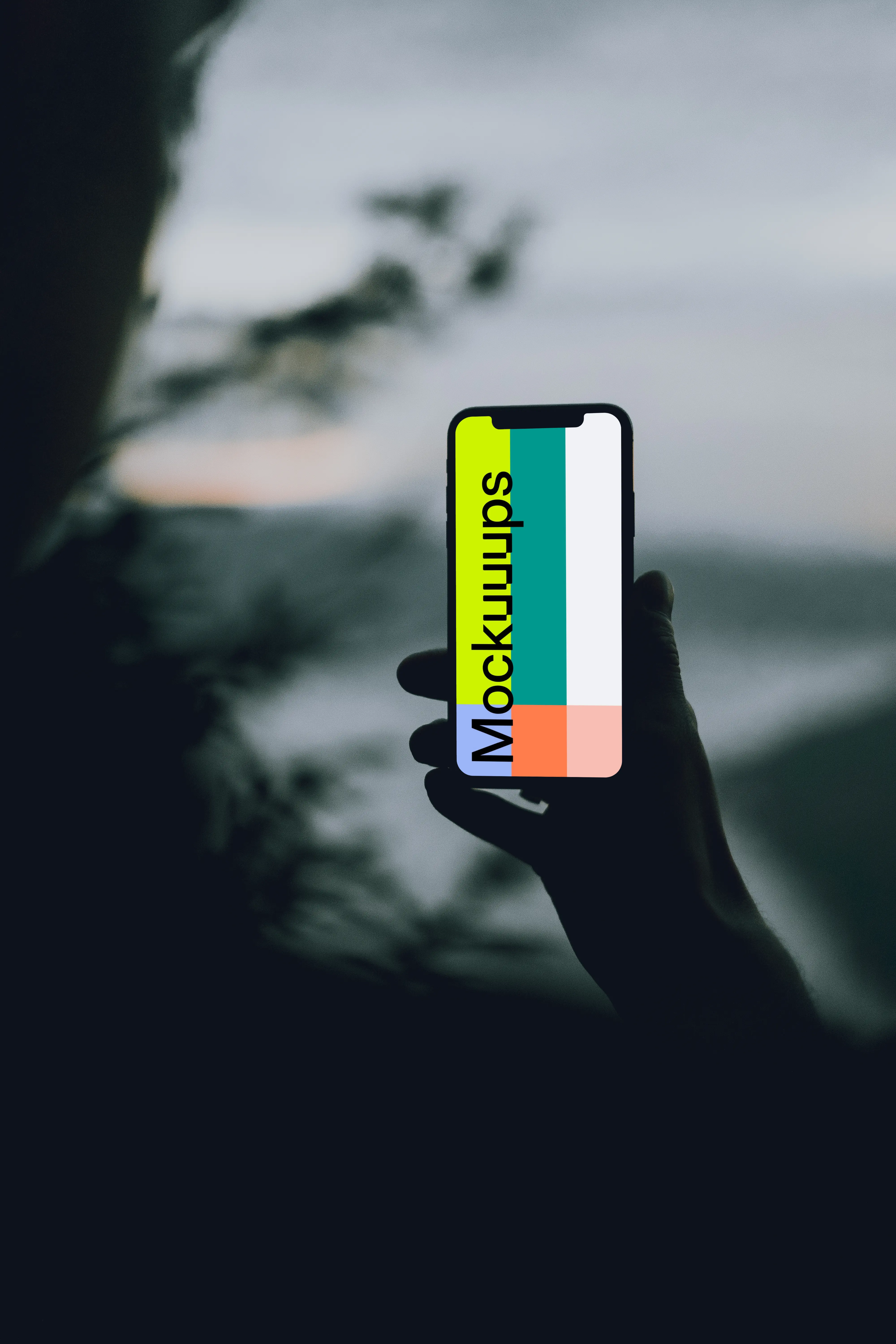 iPhone 12 Pro mockup held by a user