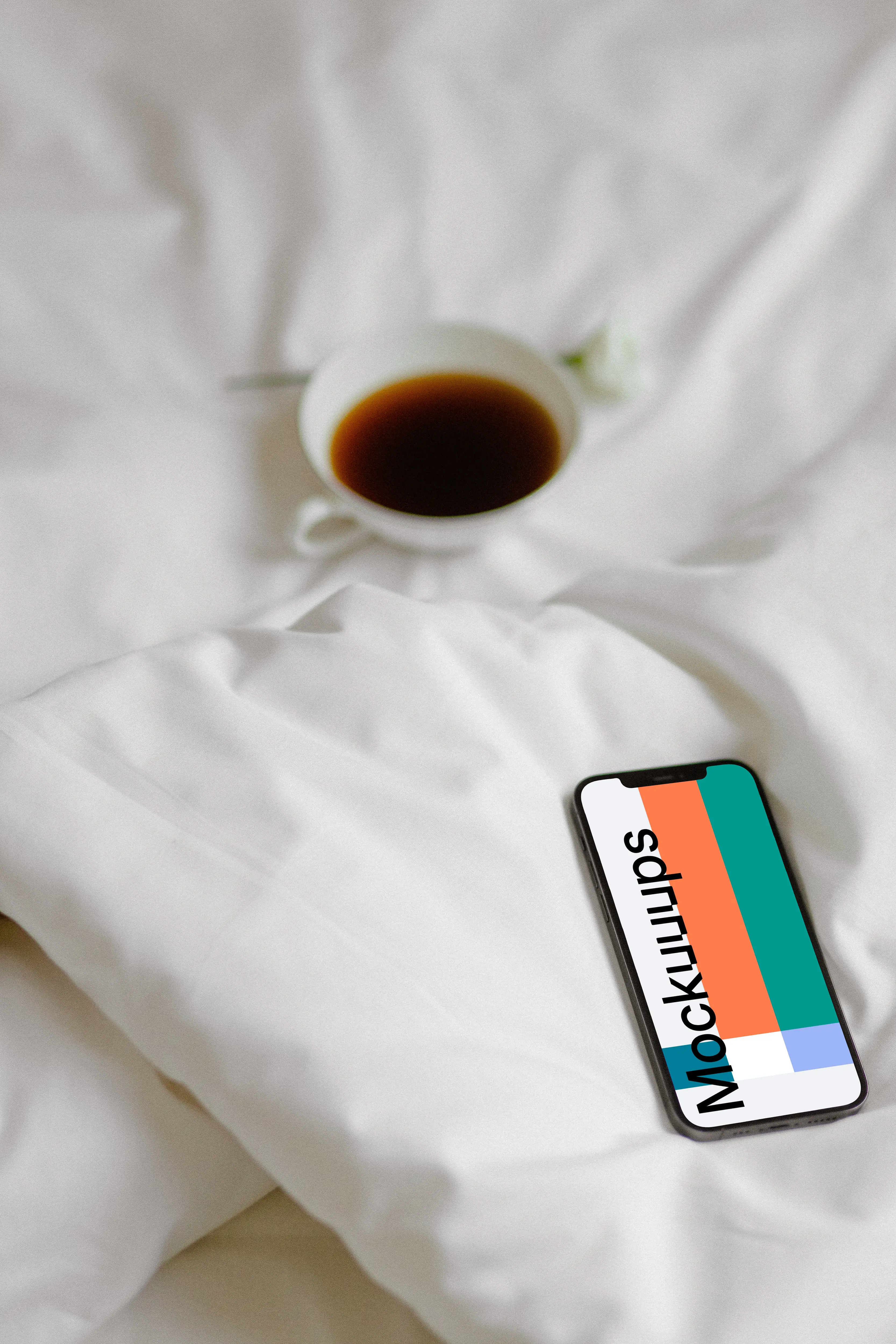 iPhone 12 Pro mockup on a bed