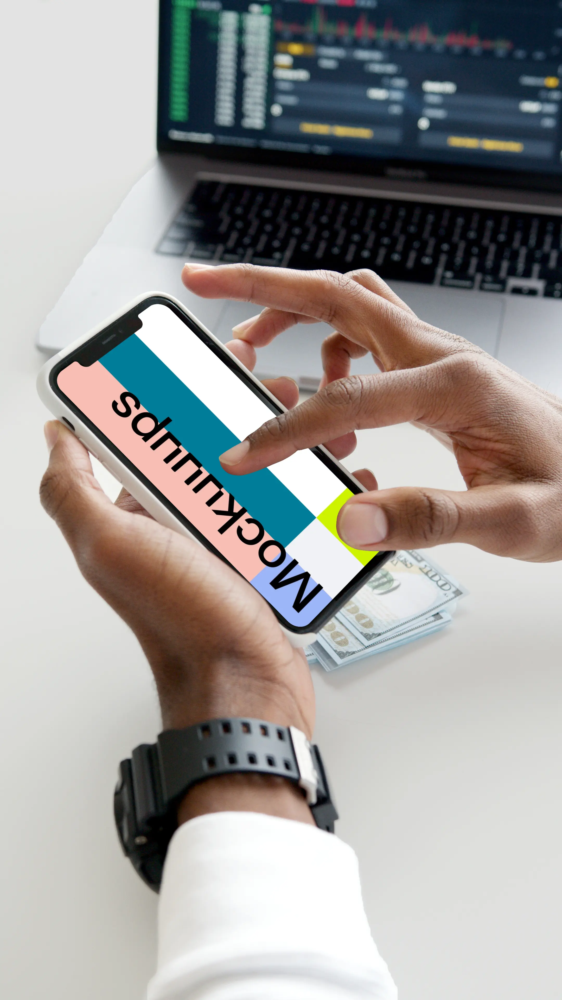 iPhone mockup in user’s hand with a MacBook