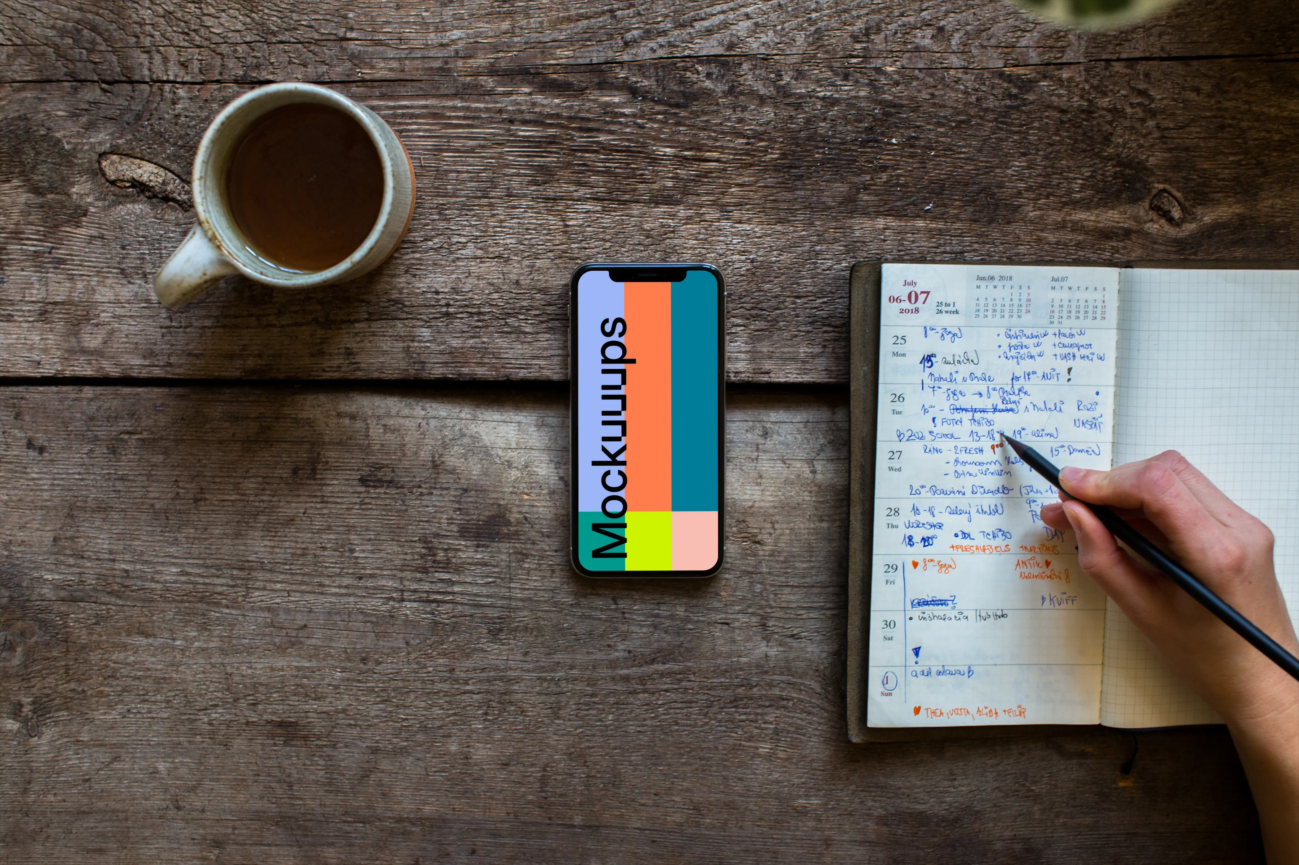 iPhone XS mockup on wooden table