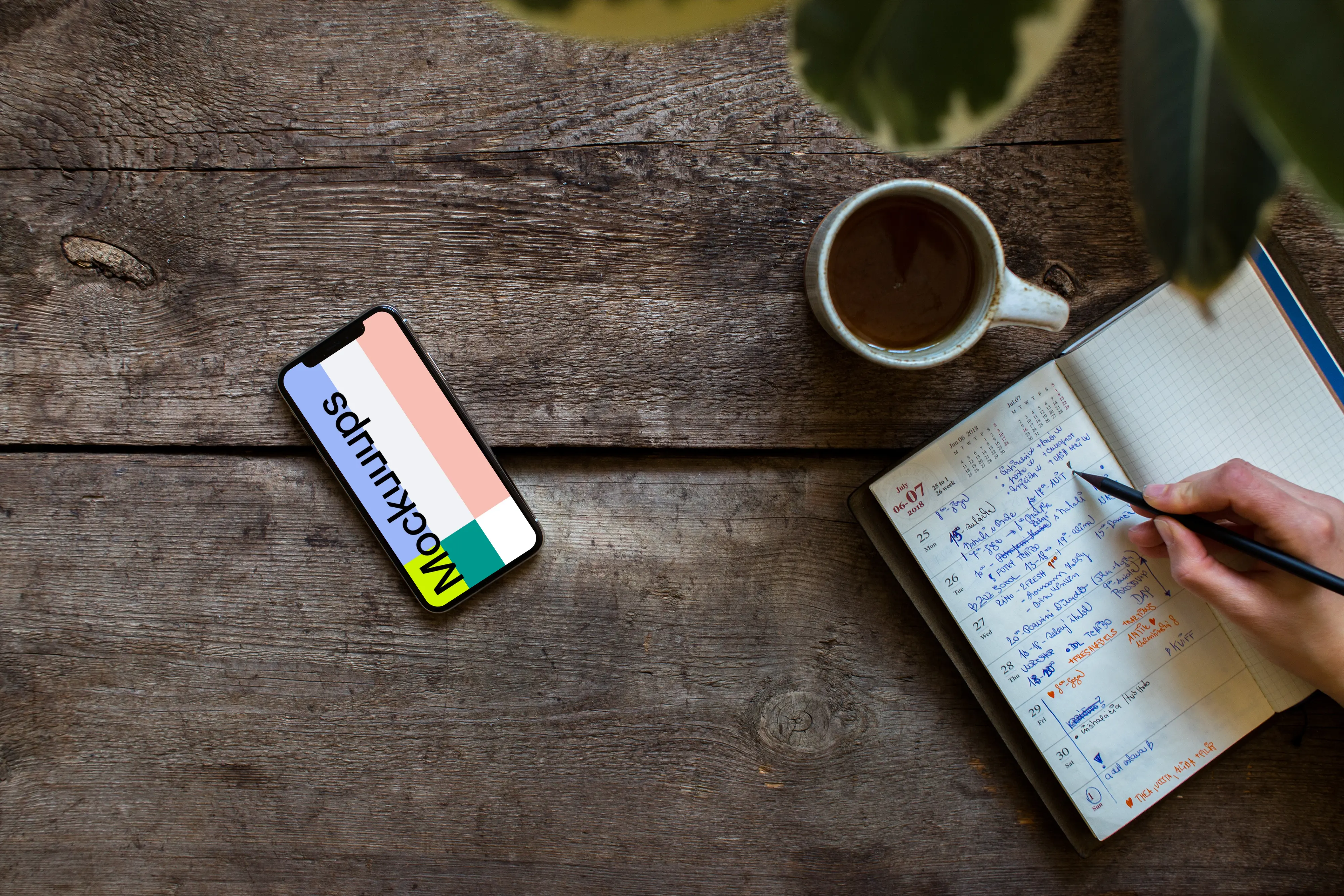 iPhone XS mockup with a journal on the right side