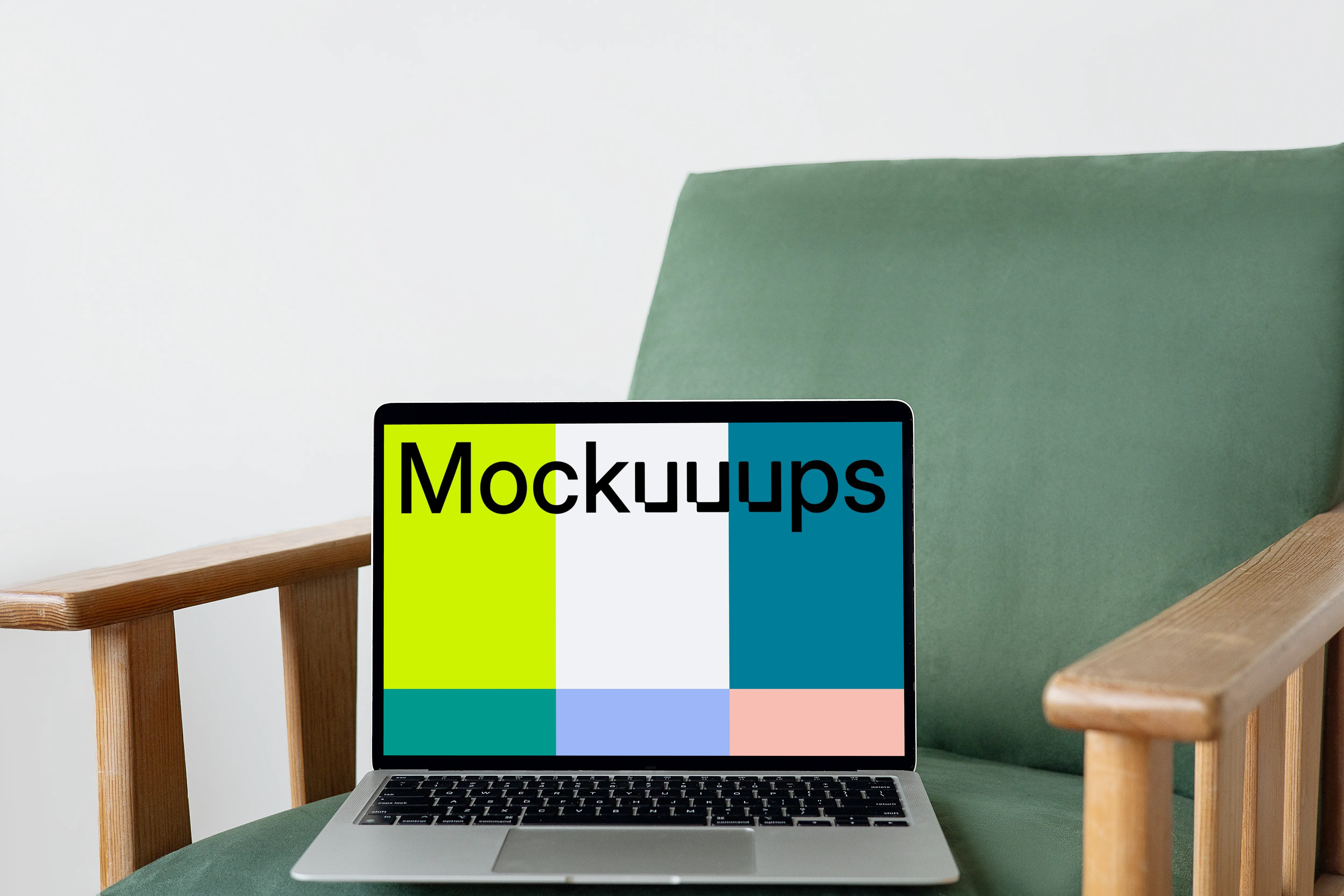 MacBook mockup on a green chair with wooden armrest