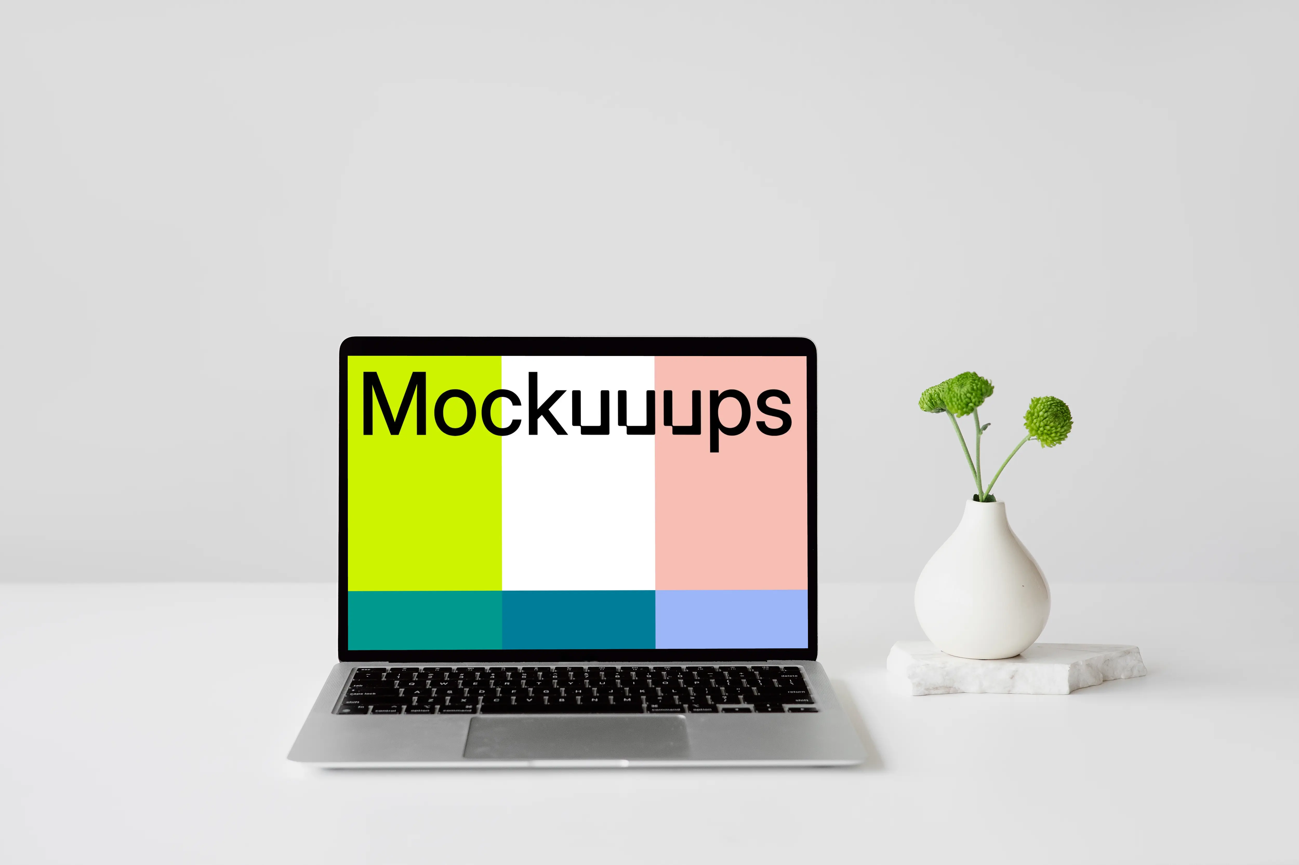 MacBook mockup on a white table with a fancy vase at the side