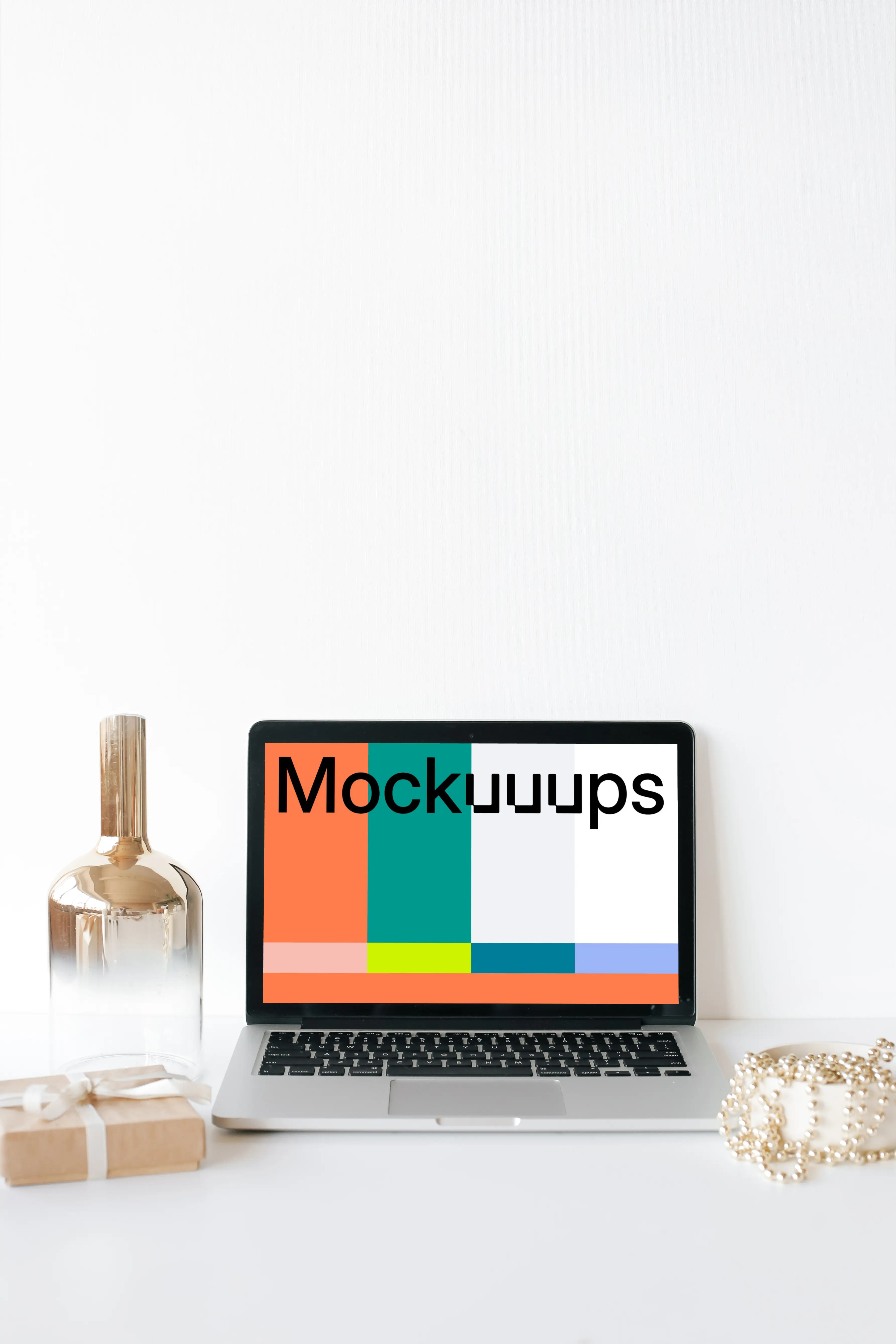 MacBook mockup on a white table with a glass jar at the side
