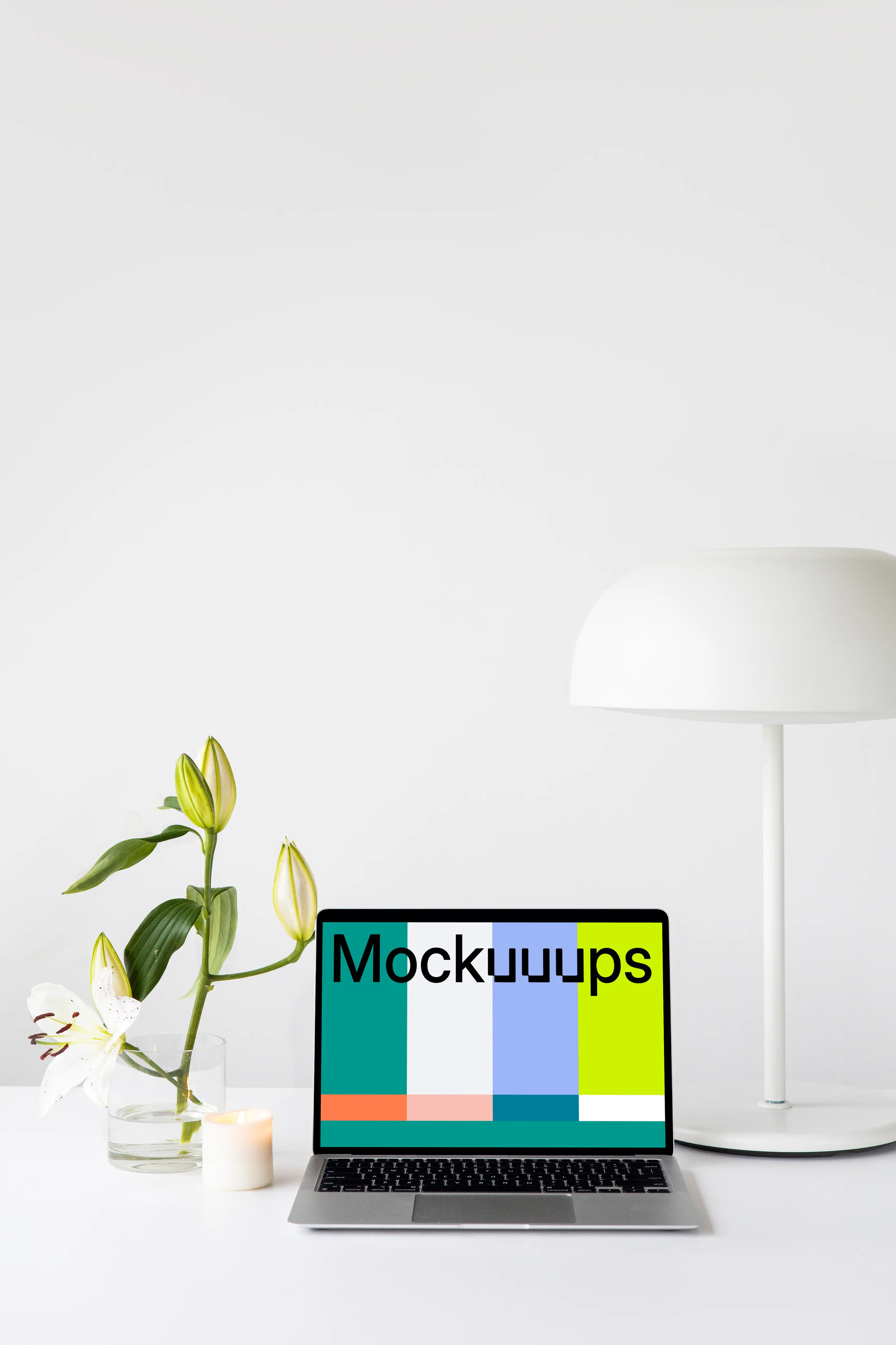 MacBook mockup on a white table with white table lamp at the side