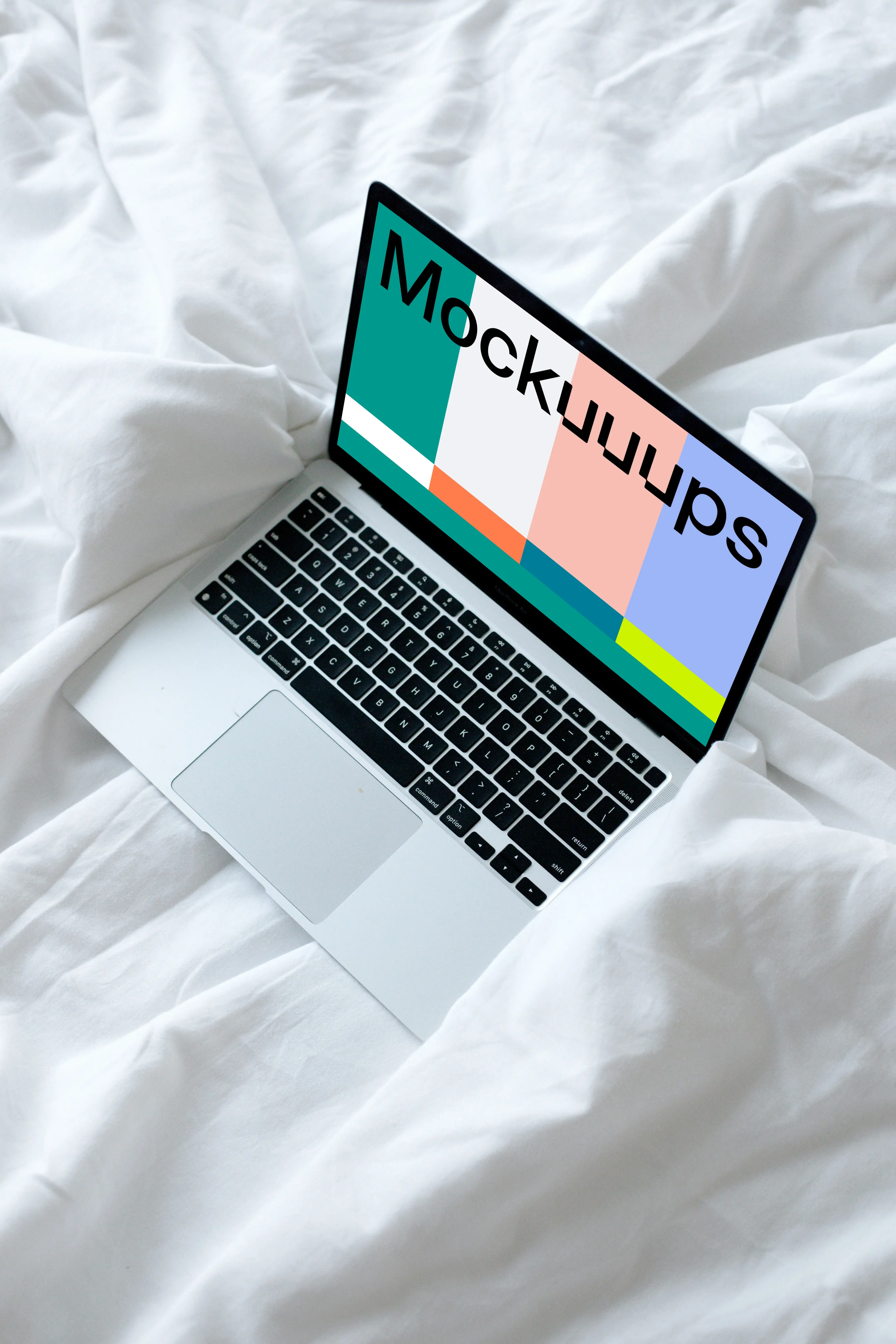 MacBook mockup resting on a white bed