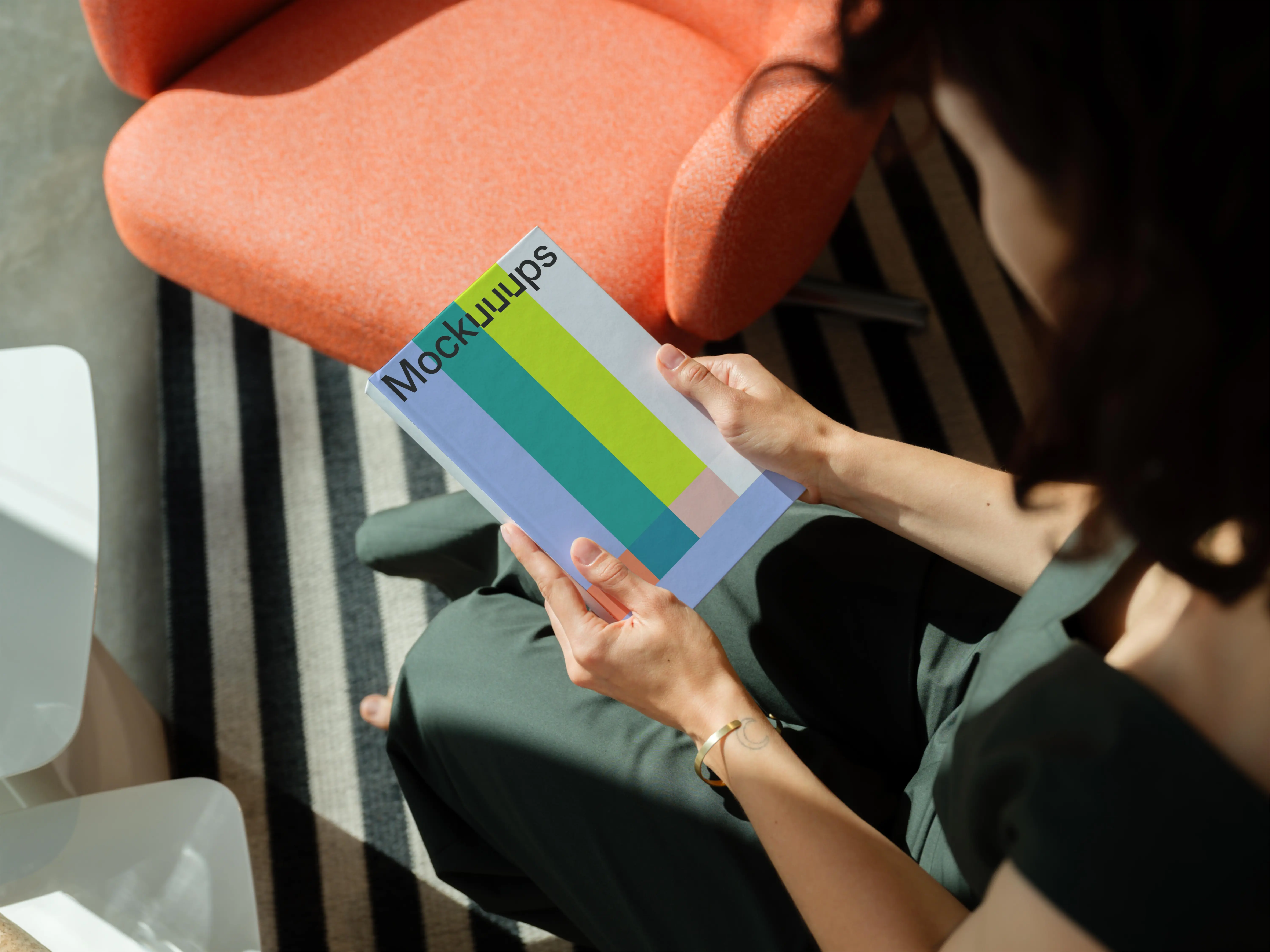 Mockup of a book held in hands with a modern interior background