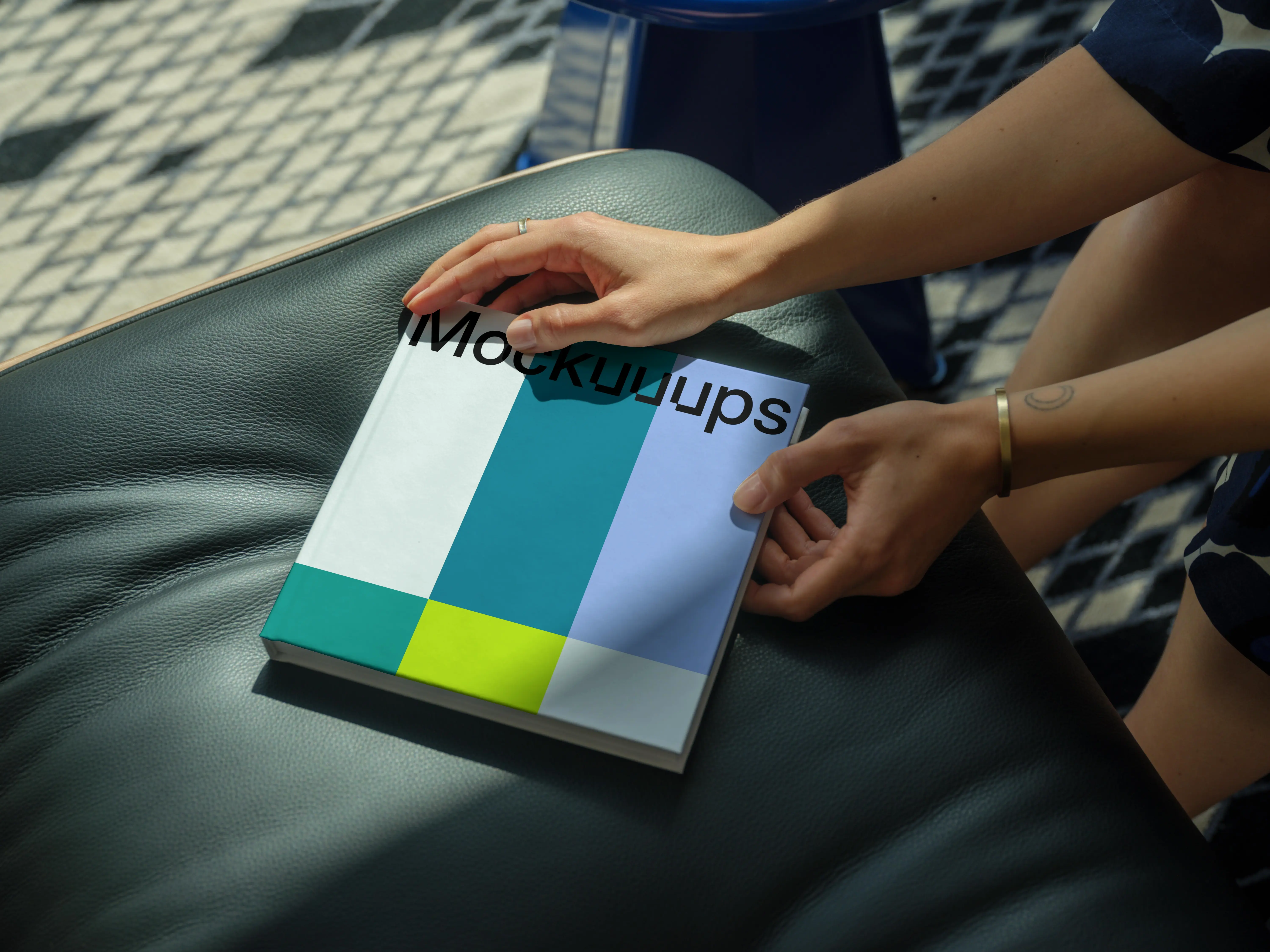 Mockup of a square book on a leather seat