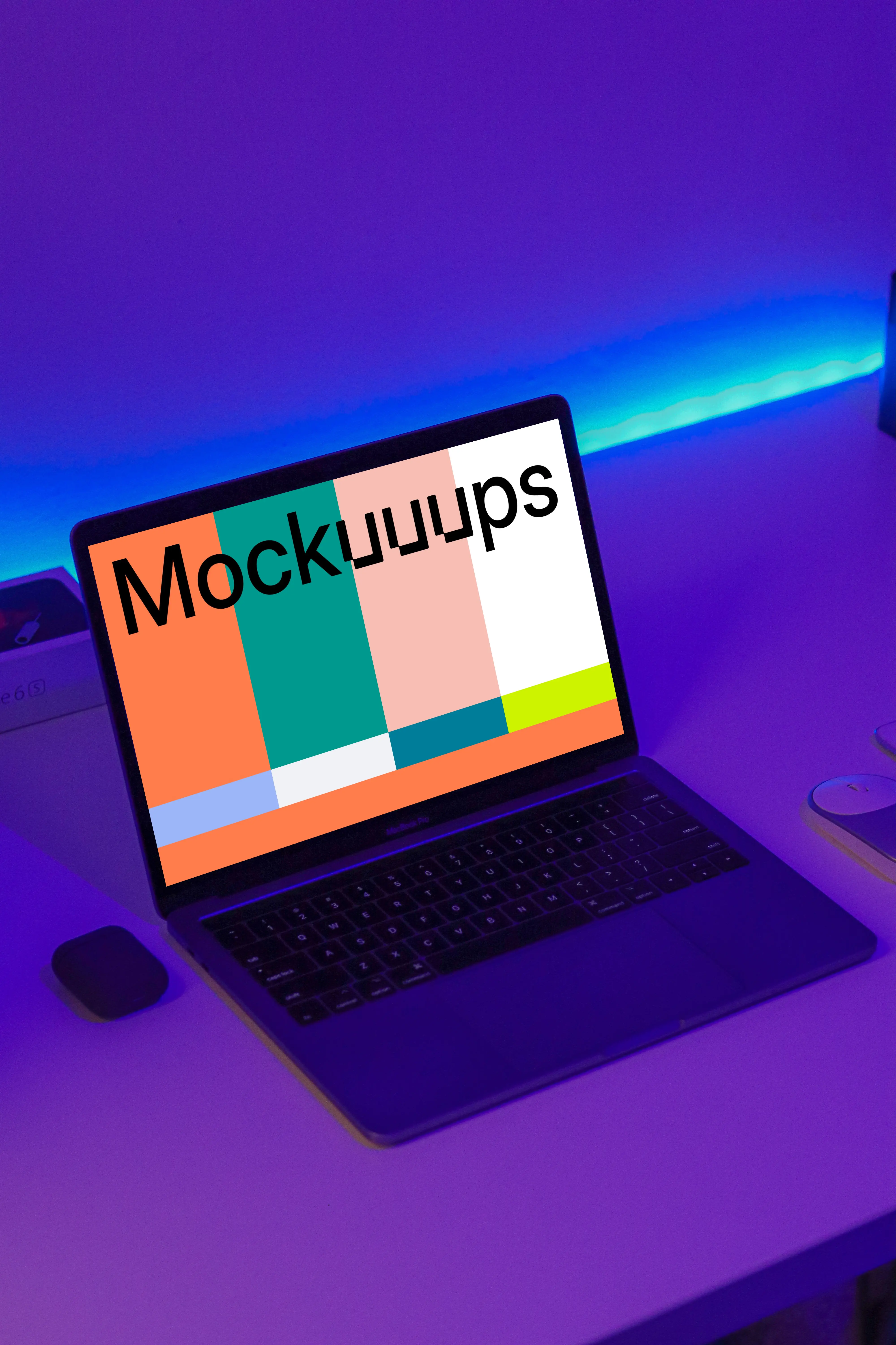 Night MacBook mockup on a table with Airpod case