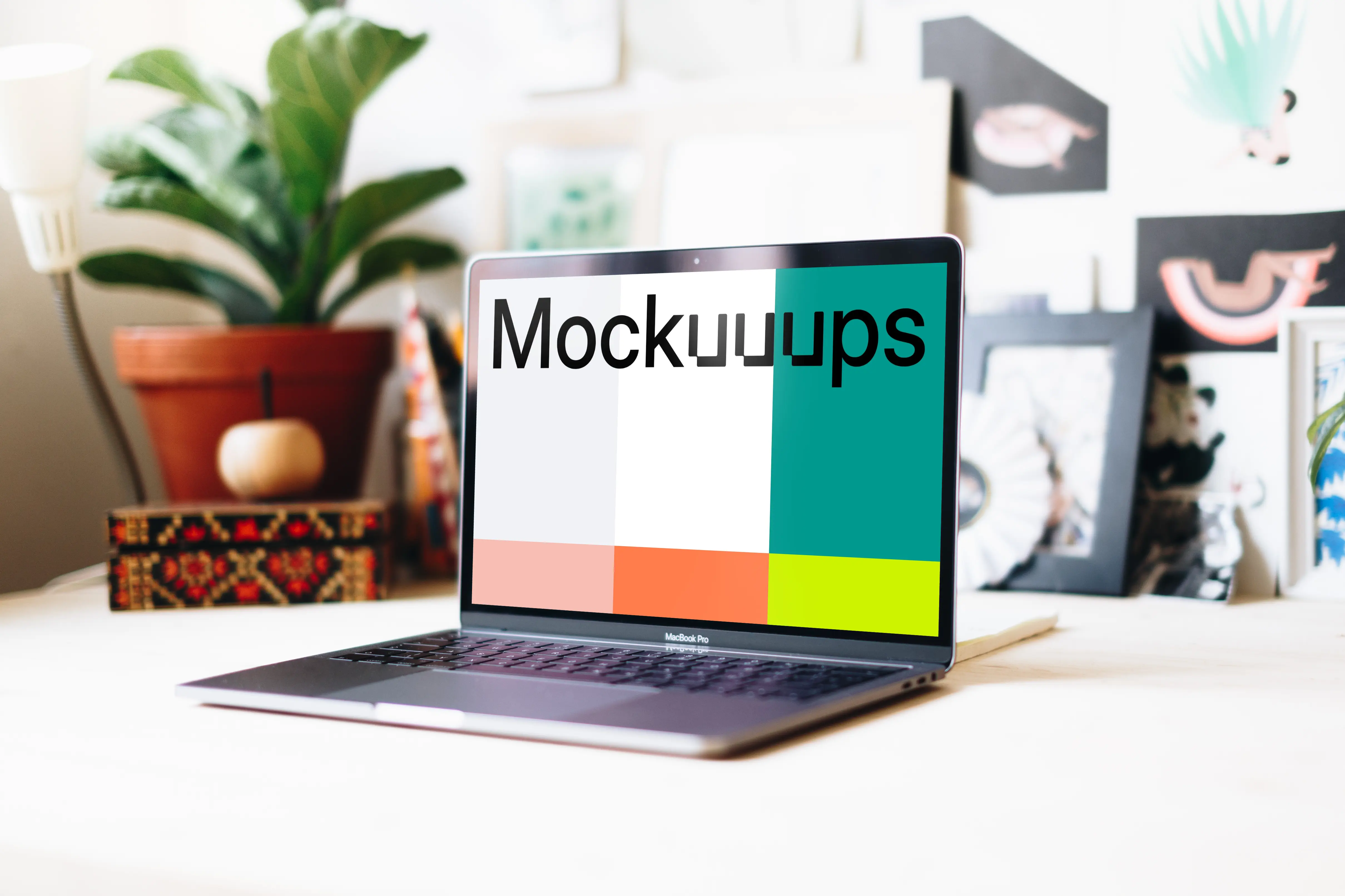 Side view of Macbook Pro mockup in a creative workspace