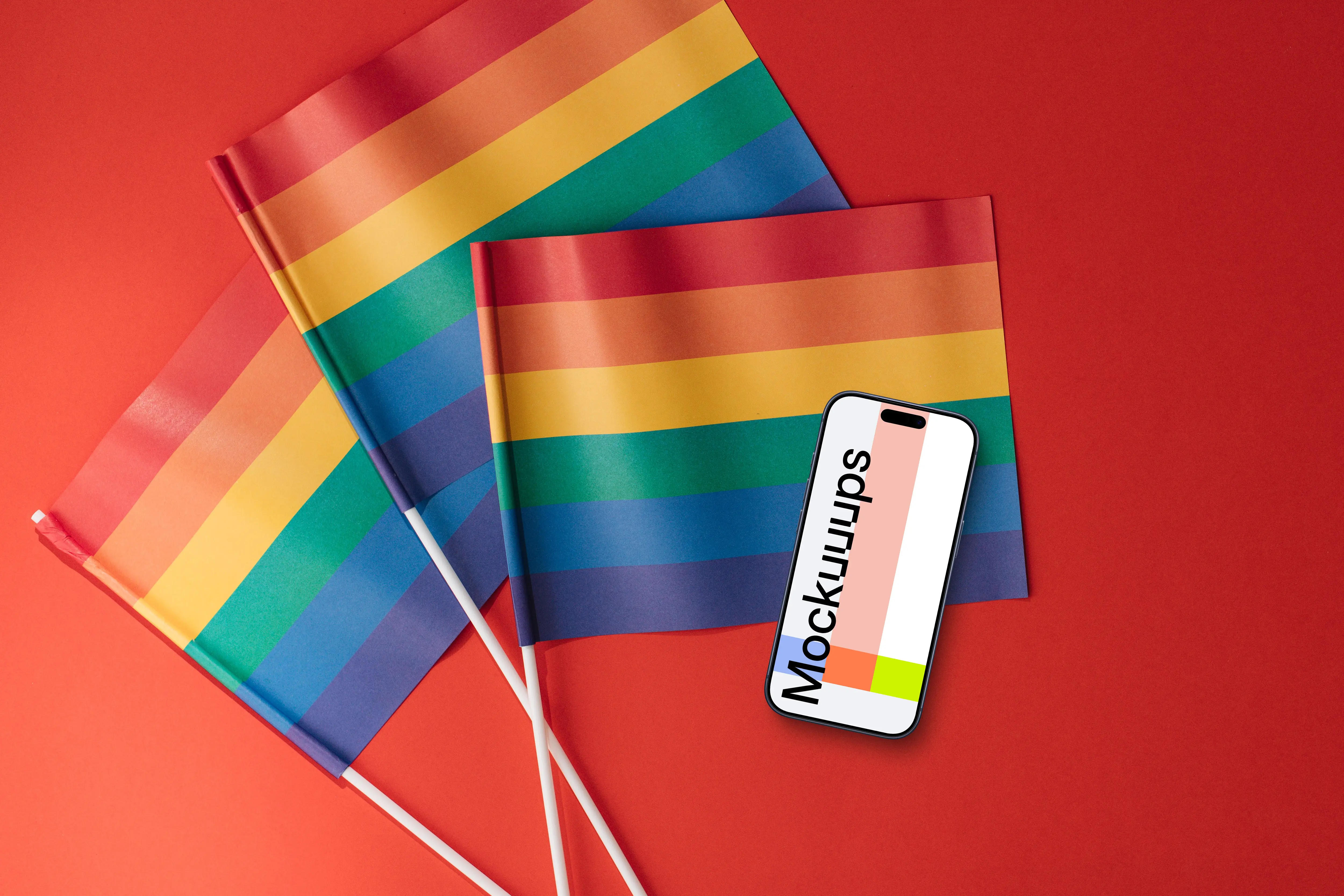 Smartphone mockup atop three rainbow flags