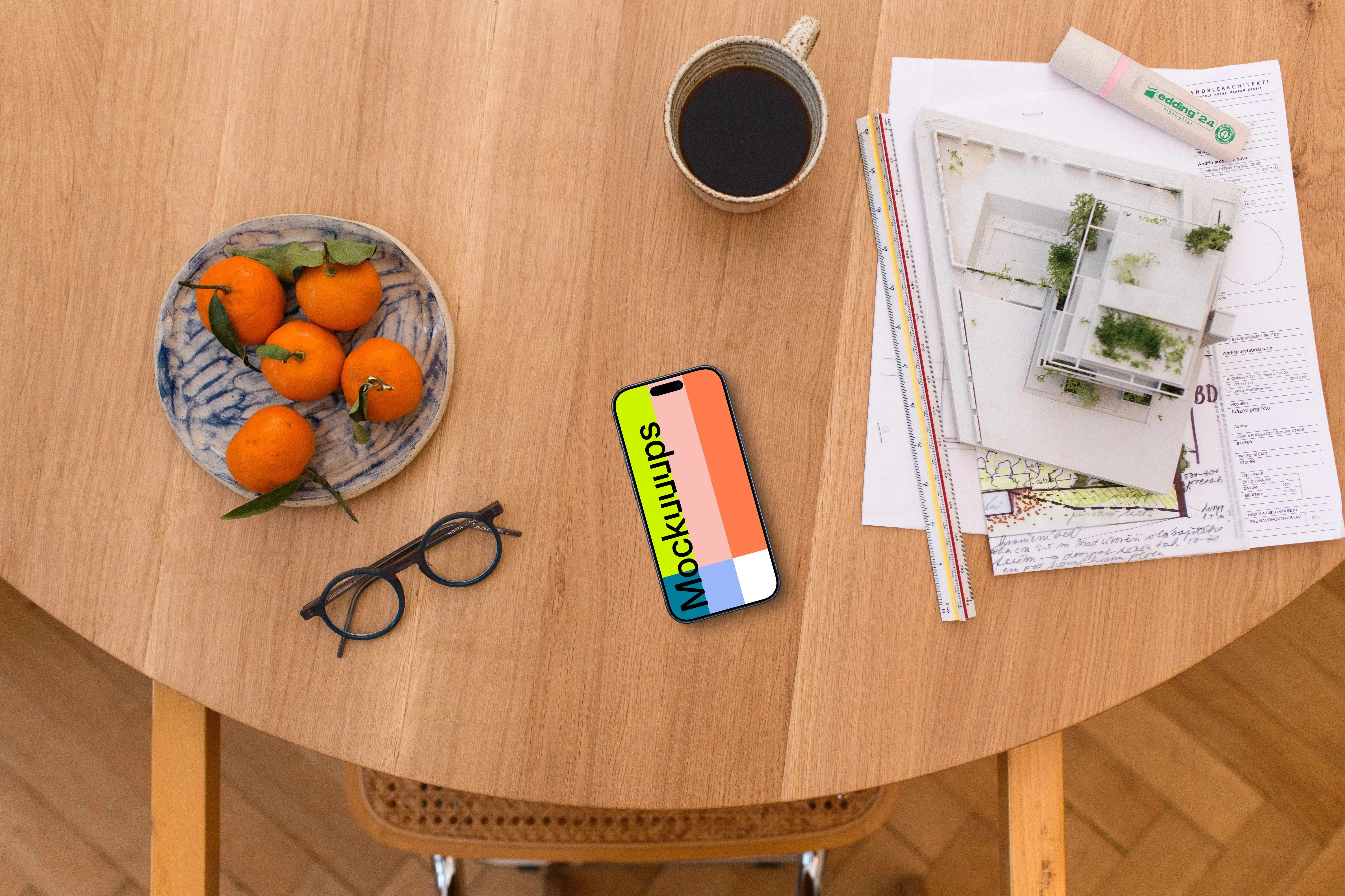 Smartphone mockup with architect's plans and coffee