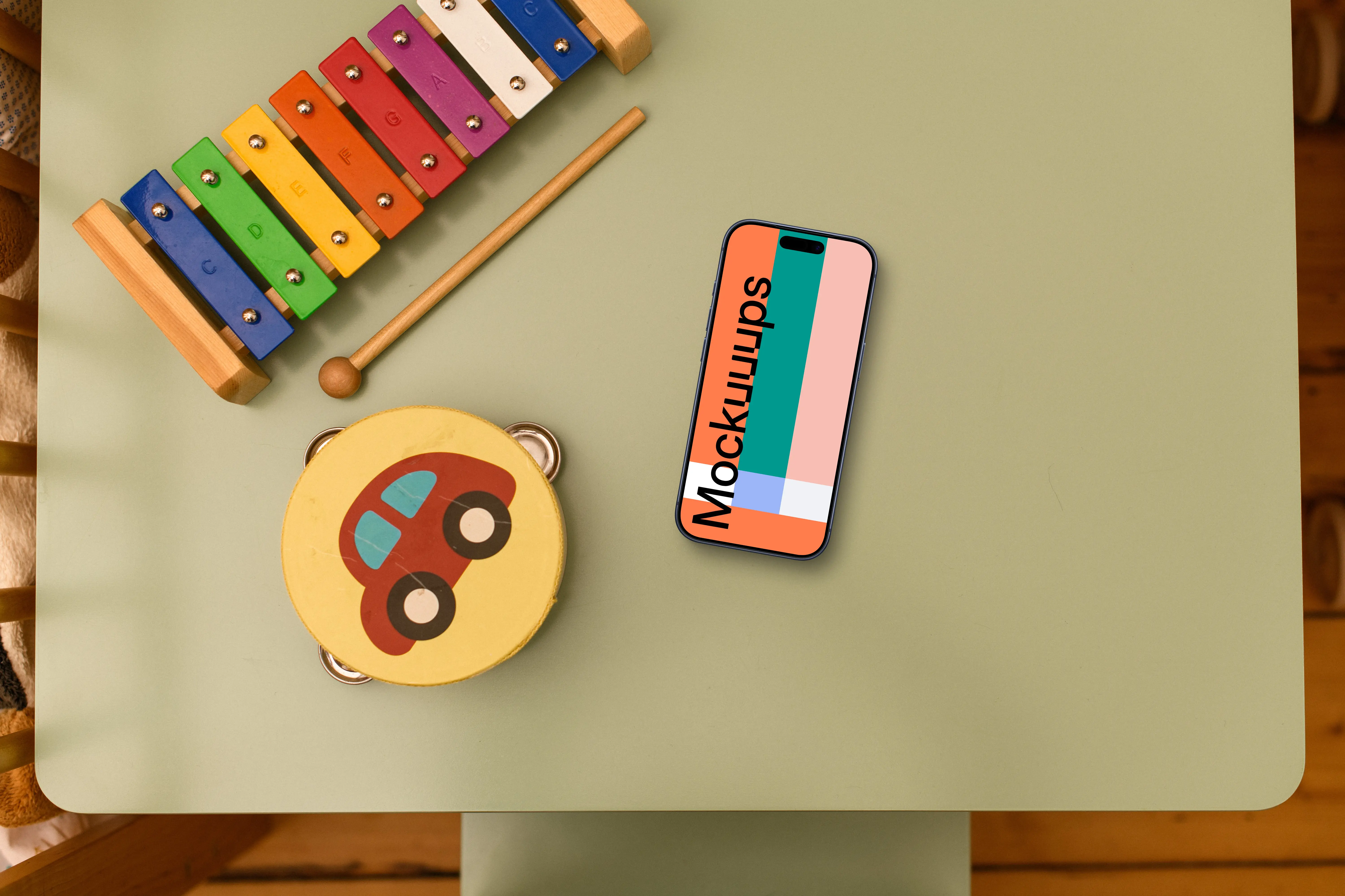 Smartphone mockup with children's toys on table