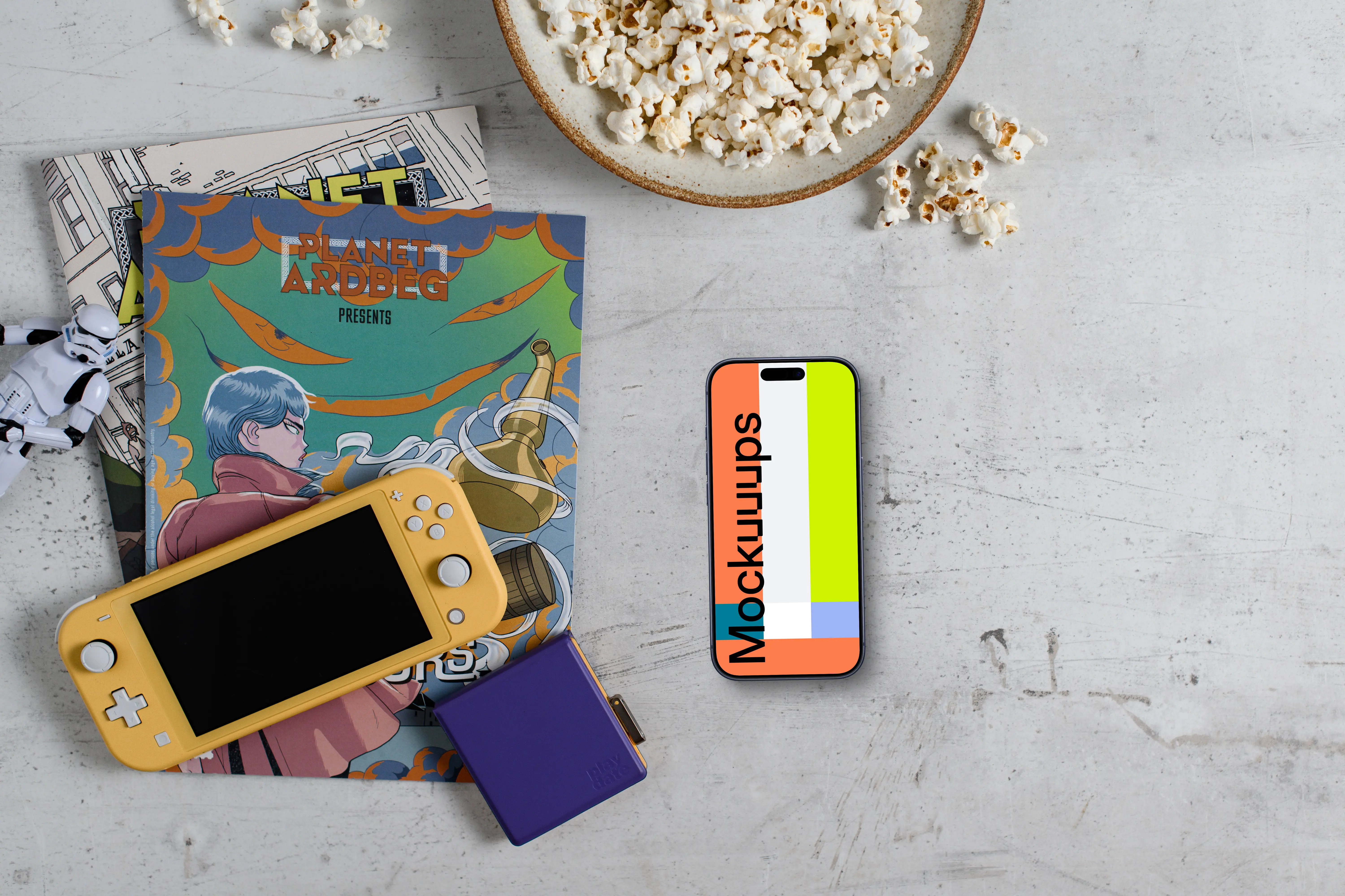 Smartphone mockup with gaming handheld and snacks