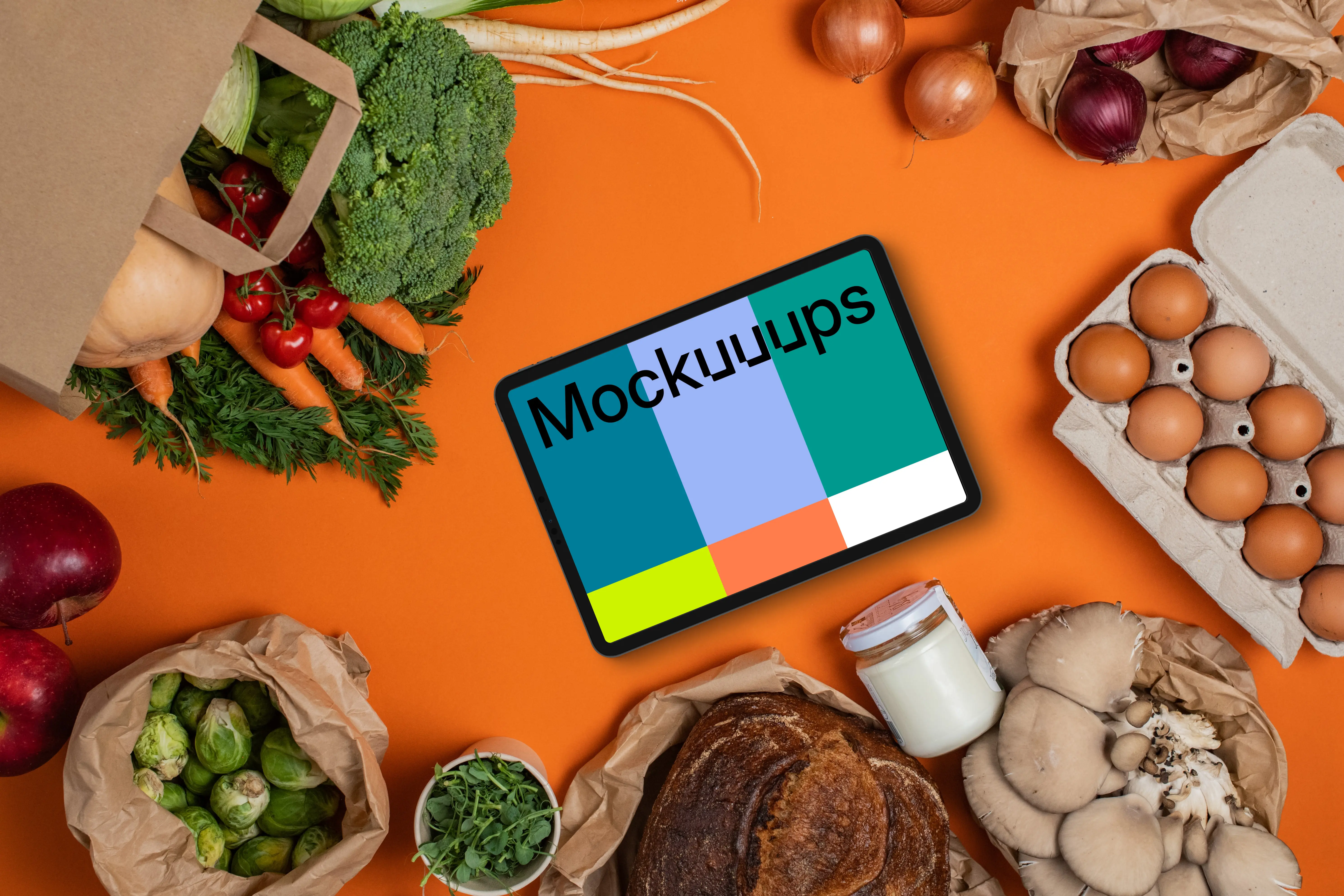 Tablet mockup surrounded by fresh groceries