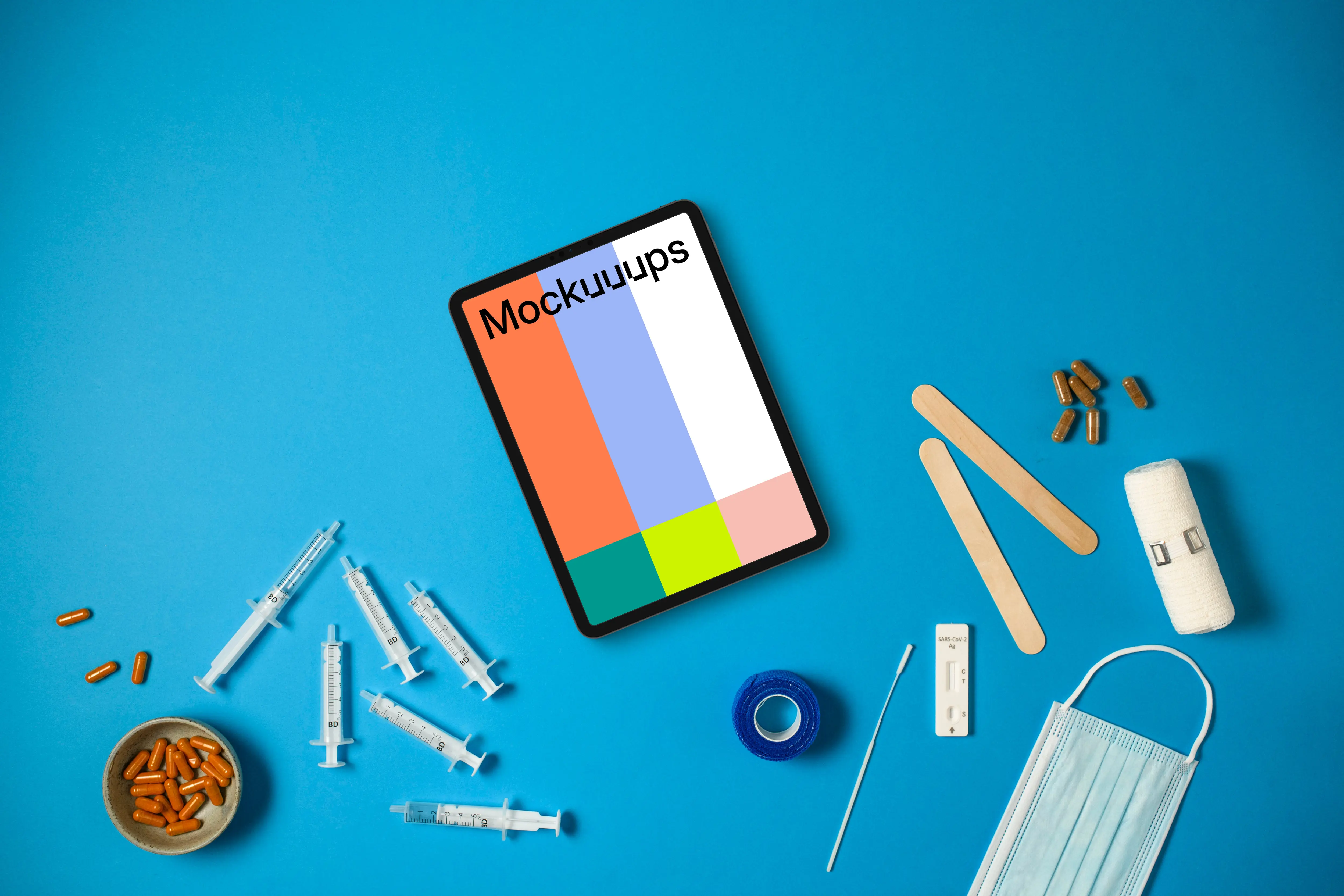 Tablet surrounded by medical essentials