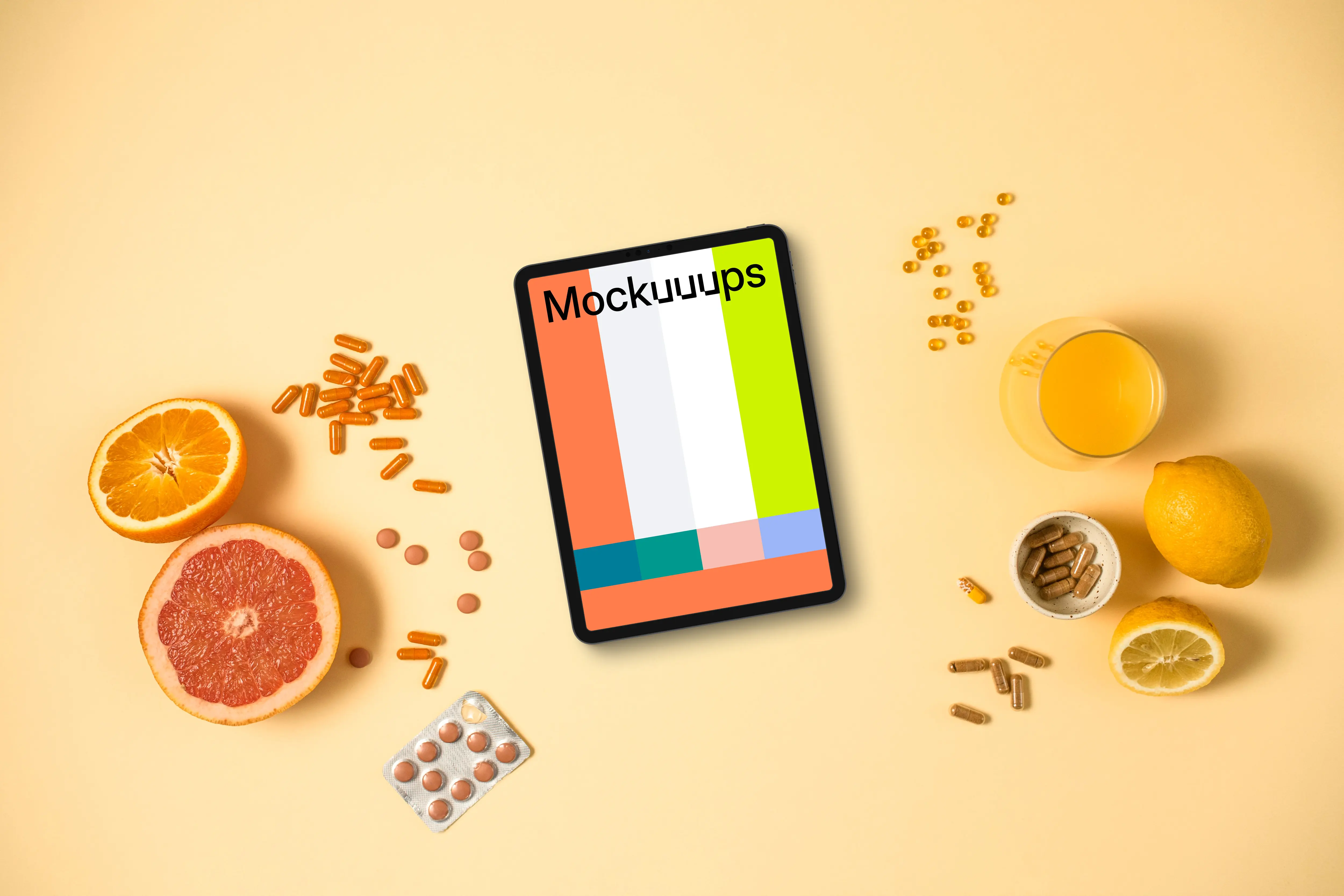 Tablet surrounded by pills and citrus fruits