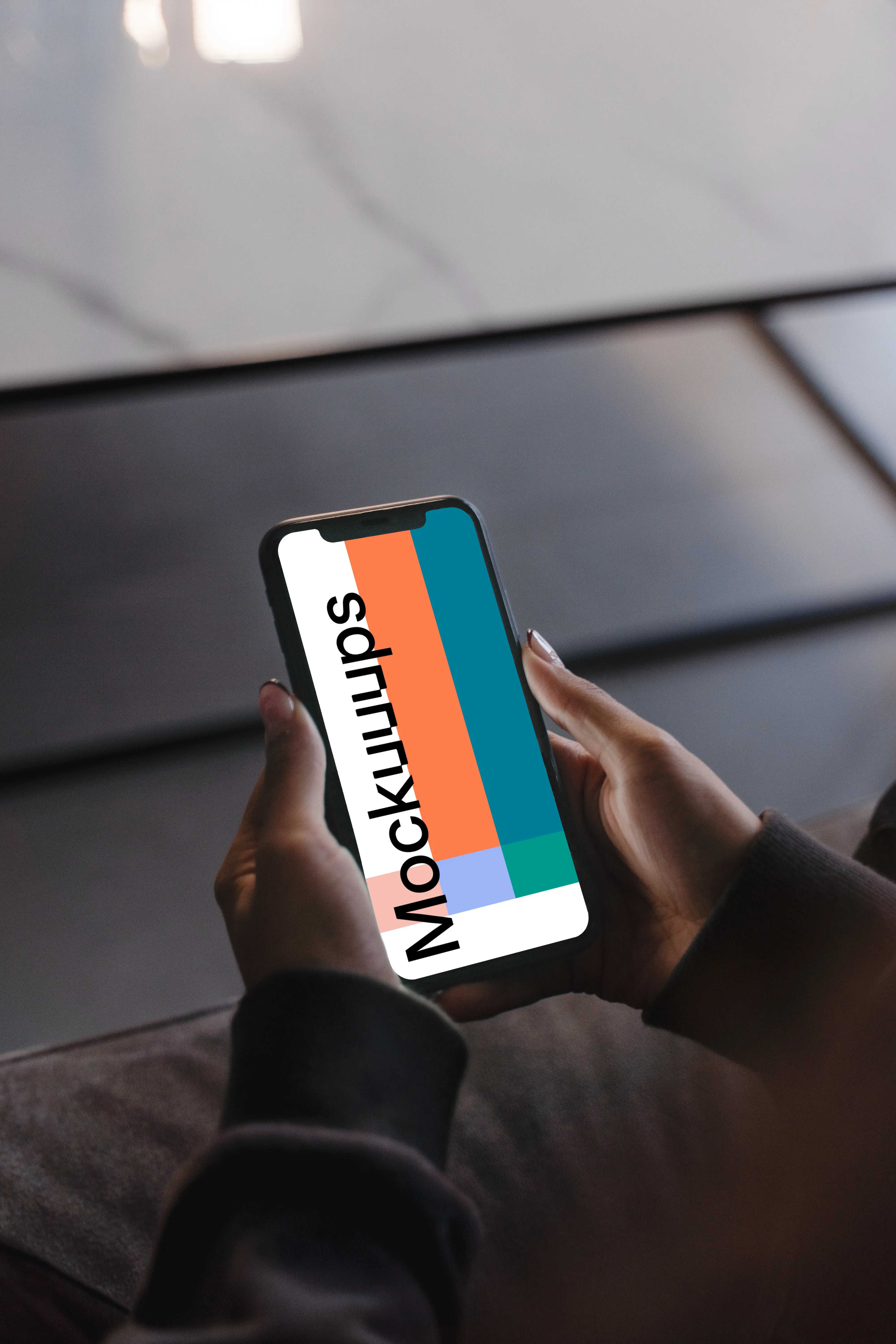 User holding an iPhone in both hands mockup