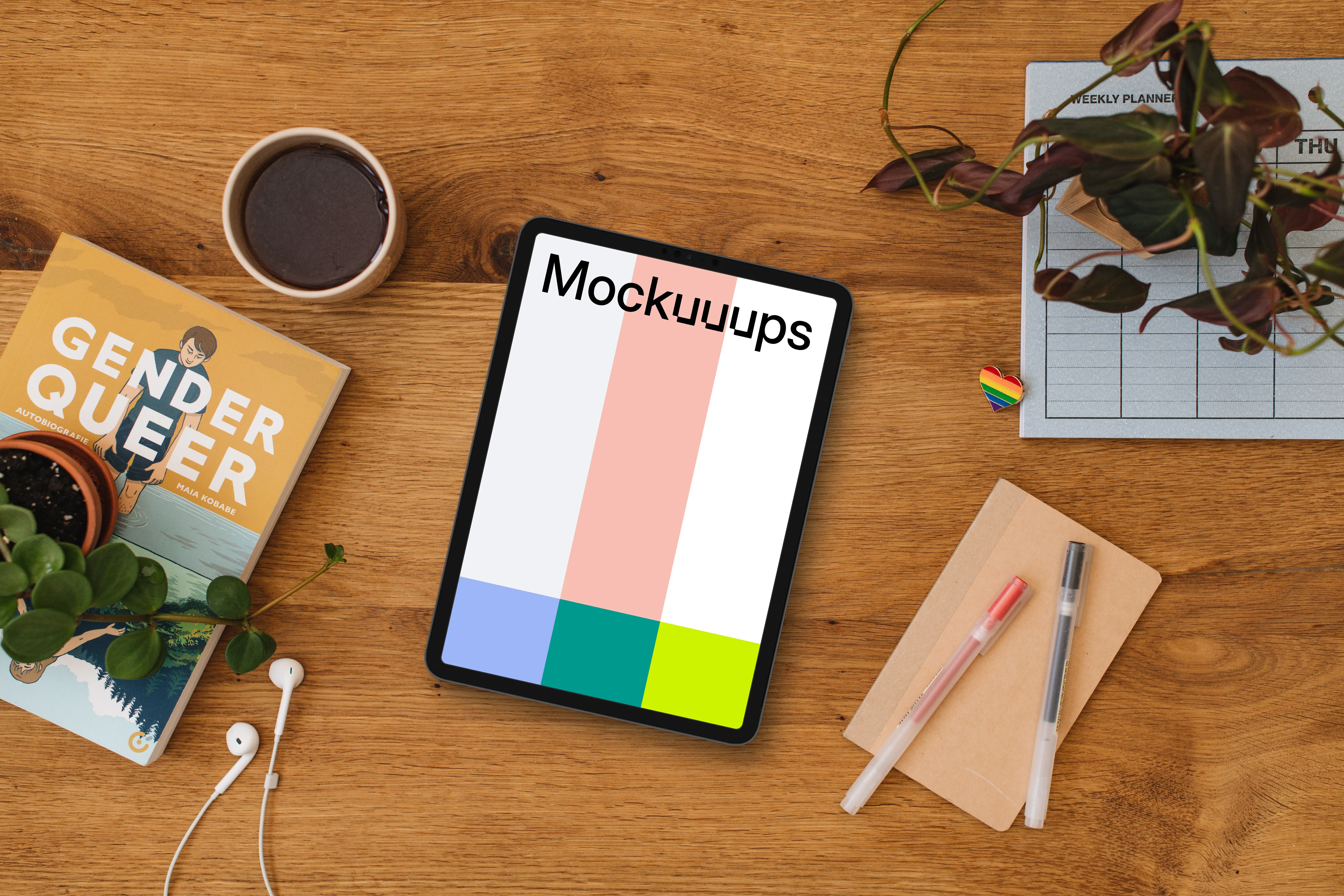 Wooden table with a tablet mockup and a pride pin