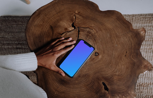 iPhone mockup on a wooden table