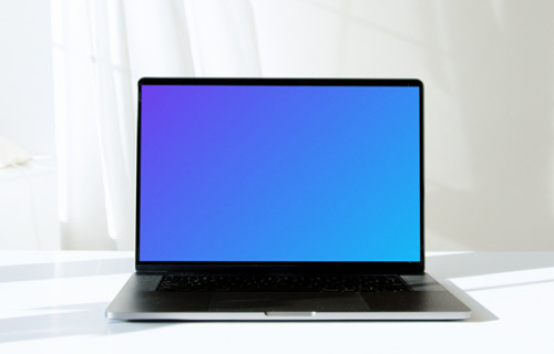 MacBook Pro mockup in full view on a white table