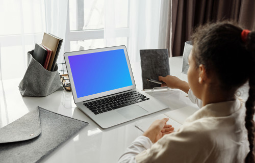 Mockup of young girl using a white MacBook Air
