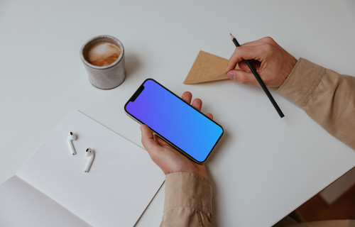 Person holding iPhone Mockup