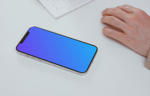 Simple iPhone mockup on a white table with a user writing by the side