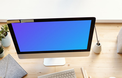 Dark haired kid using an iMac mockup