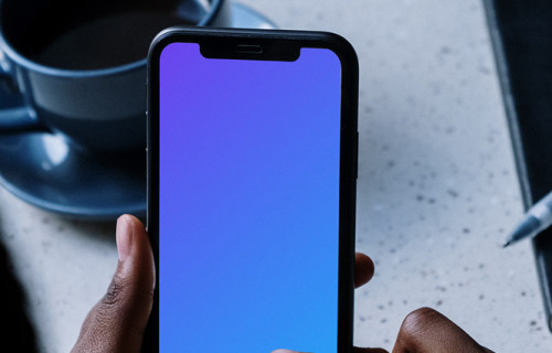 iPhone mockup beside a cup of coffee