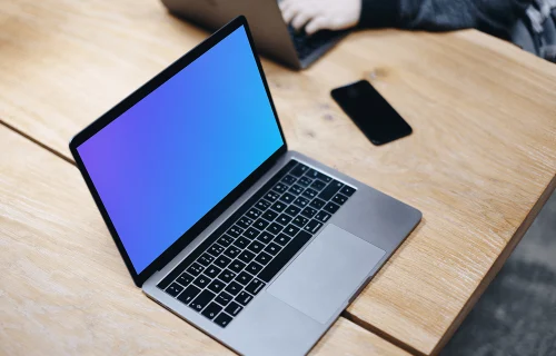 Free Macbook Pro Space Gray mockup on the wooden table