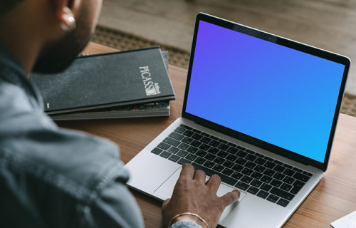 Man shopping on his grey MacBook mockup  