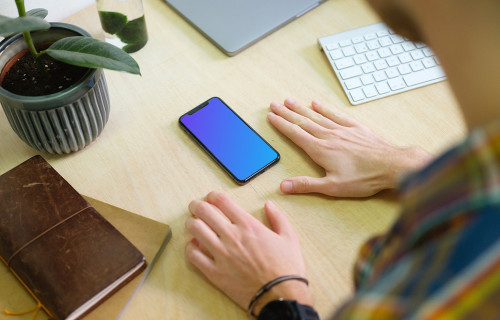 Man with iPhone 11 mockup in the office