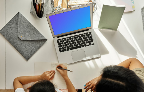 Mockup of adult teaching a kid using a MacBook Air