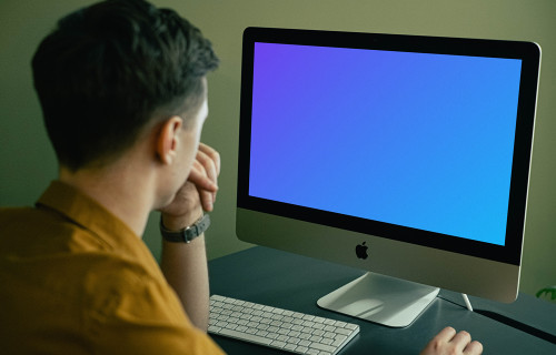Mockup of user staring at his iMac when working