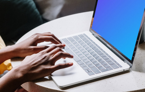 White MacBook Pro mockup on table