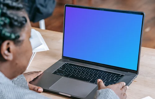 Woman using a MacBook Pro mockup