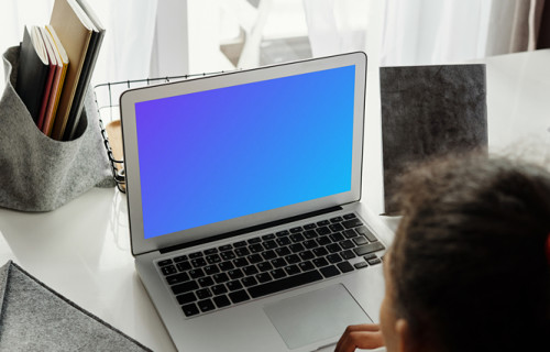 Young girl working on her MacBook Air mockup