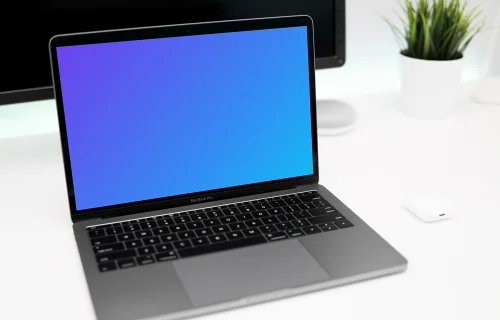 Close view of Macbook Pro mockup on white desk