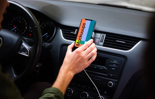 Driver placing iPhone 11 mockup in car mount