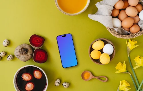 Easter eggs being colored around a smartphone mockup