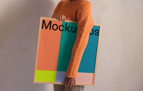 Framed mockup held by person in casual outfit