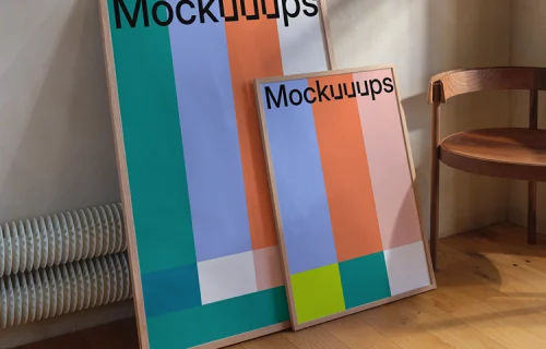 Framed poster mockup leaning against a wall with chair