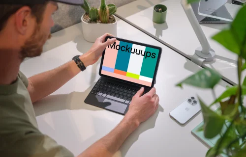 iPad Air mockup in a modern office held by a man