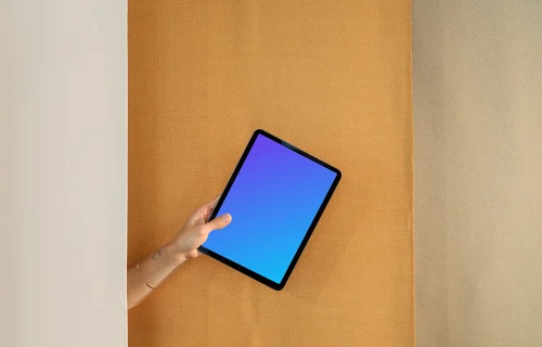 iPad Air mockup with a person holding it against a dual-tone backdrop