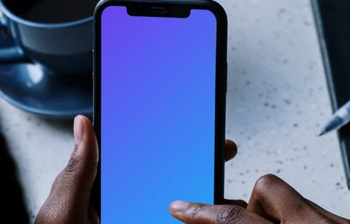 iPhone mockup beside a cup of coffee
