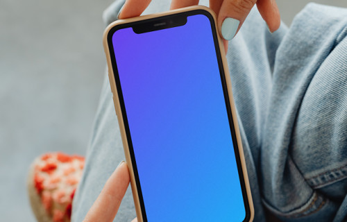 iPhone mockup hand held by user above her laps